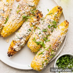 Mexican street corn on the cob with cheese and cilantro on top