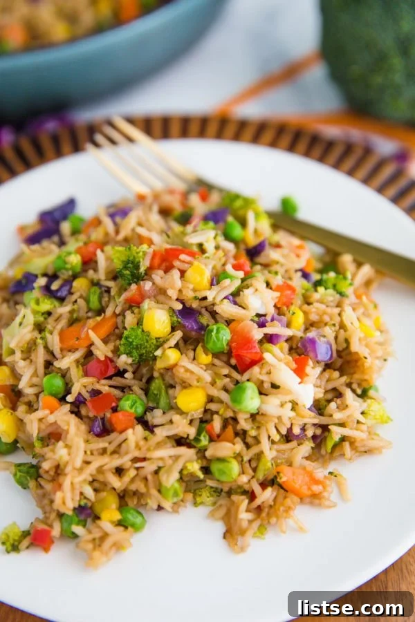 Delicious and healthy Loaded Veggie Fried Rice, a vibrant vegan dish packed with fresh vegetables.