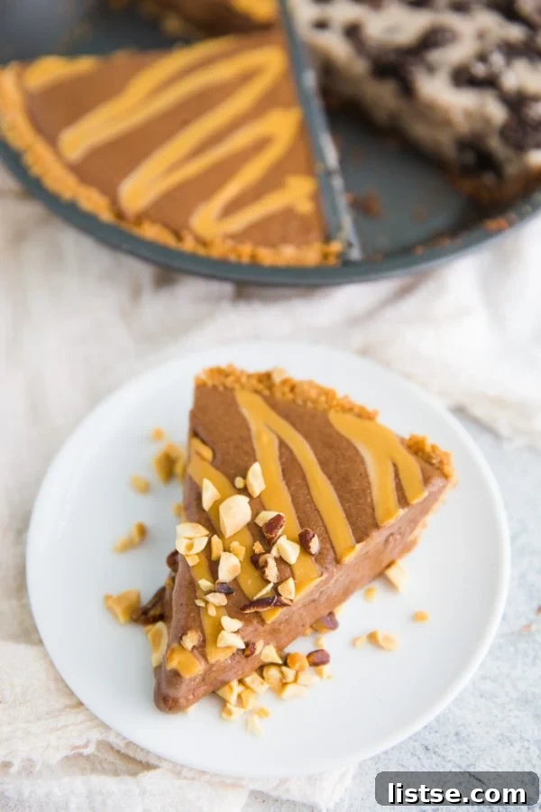 Balanced Bliss Pie 7 A slice of the healthy ice cream pie showing both chocolate peanut butter and Oreo layers.