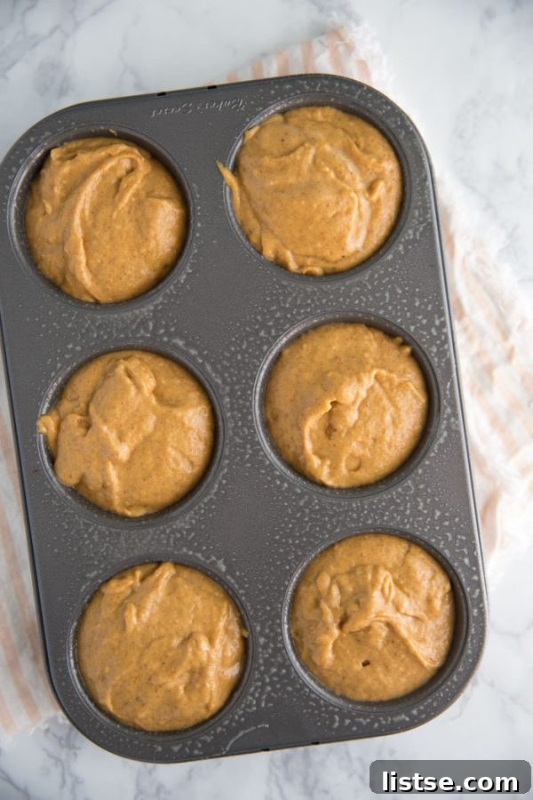 Delicious vegan pumpkin muffins arranged on a rustic wooden board