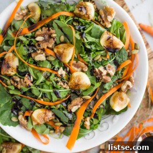 A vibrant Fig and Walnut Side Salad next to a slice of pizza, showcasing the ideal pairing.