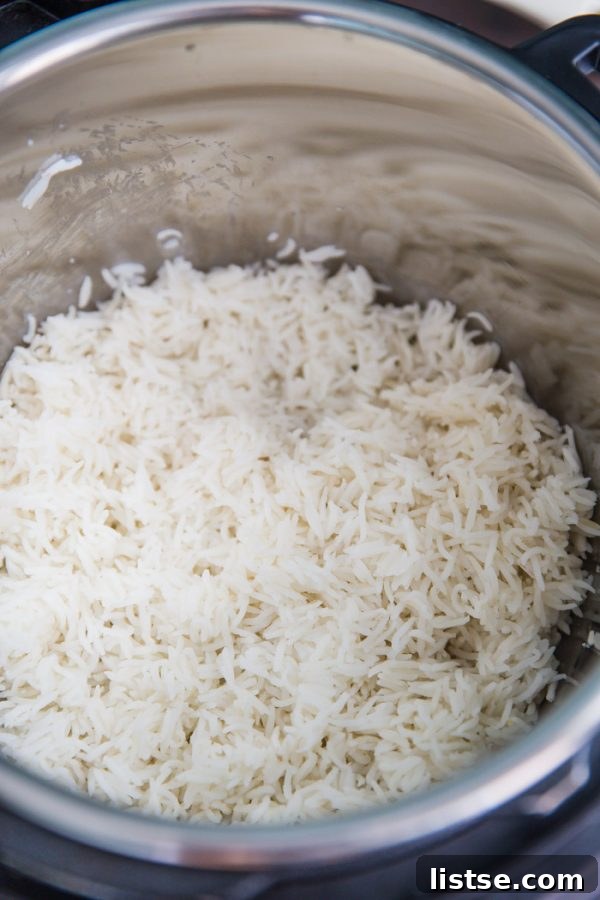 Fluffy Instant Pot Basmati Rice 4 Basmati rice grains being fluffed with a fork after cooking in the Instant Pot, highlighting its perfect texture
