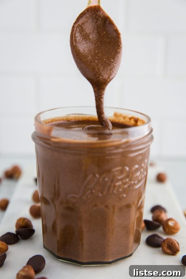 Delicious homemade vegan Nutella in a jar, showcasing its smooth, rich texture and inviting color.