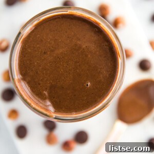 Freshly made homemade Nutella in a jar, highlighting its rich, creamy texture.