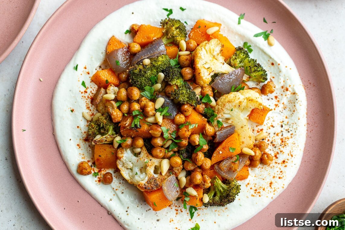 pink plate with whipped feta and roasted veggies on it