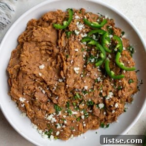 homemade refried beans in a large white bowl