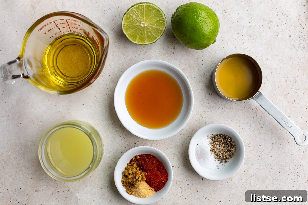 Ingredients needed to make a southwestern vinaigrette including olive oil, honey, lime juice, spices, and salt and pepper