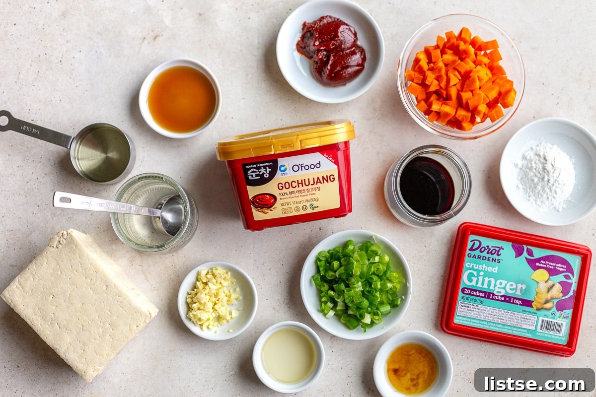 ingredients needed to make gochujang tofu including gochujang sauce, garlic, ginger, tofu, green onion and oil
