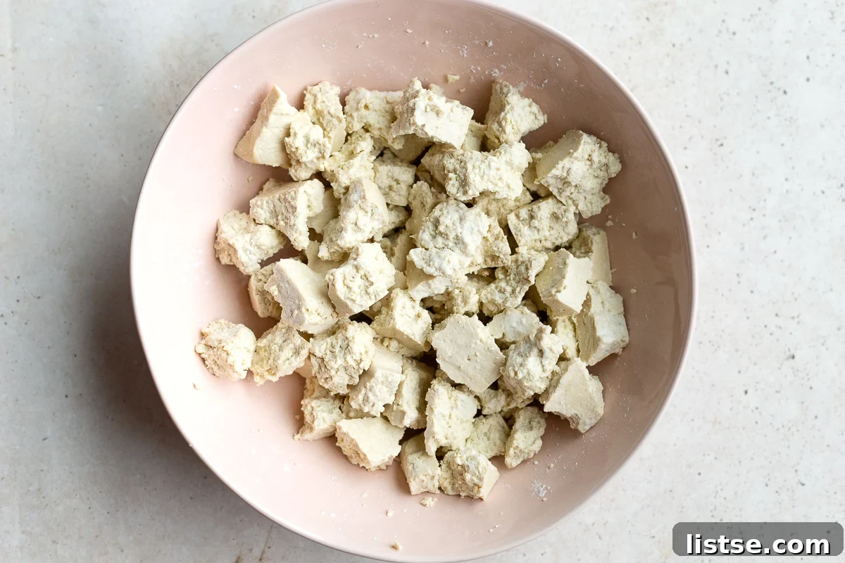 tofu chunks in a large pale pink bowl
