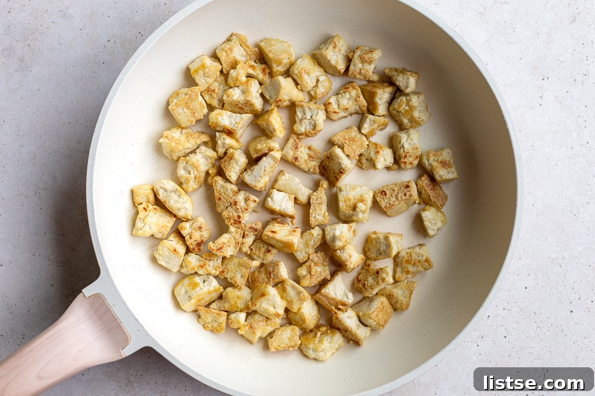 crispy tofu in a large white skillet
