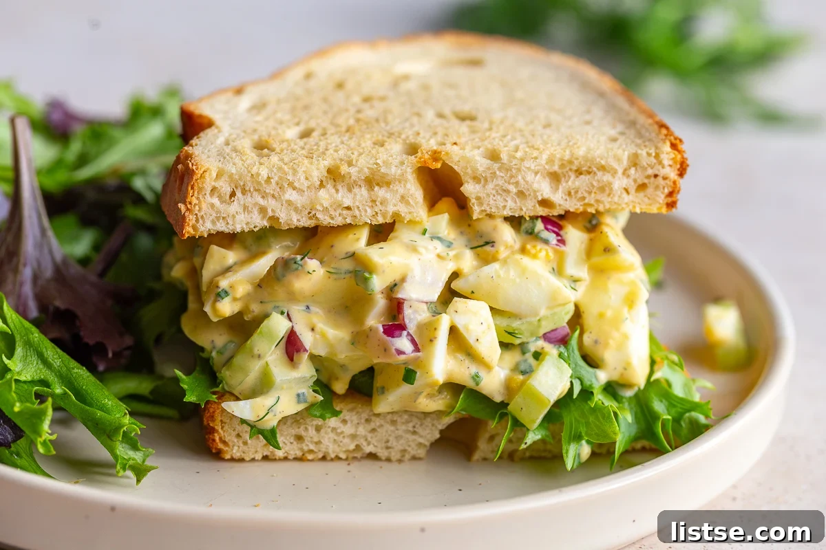 The best egg salad sandwich, generously filled with creamy egg salad and fresh greens, served on perfectly toasted bread for a satisfying and easy meal.