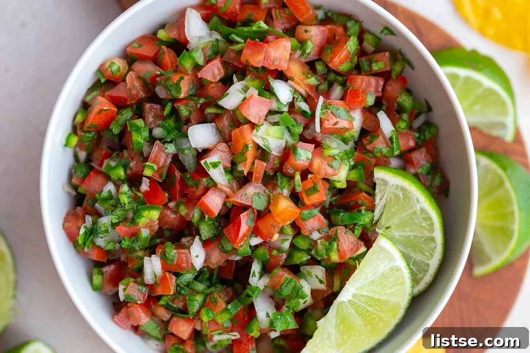 Crafting Perfect Pico de Gallo 2 pico de gallo in a white bowl with 2 limes on top