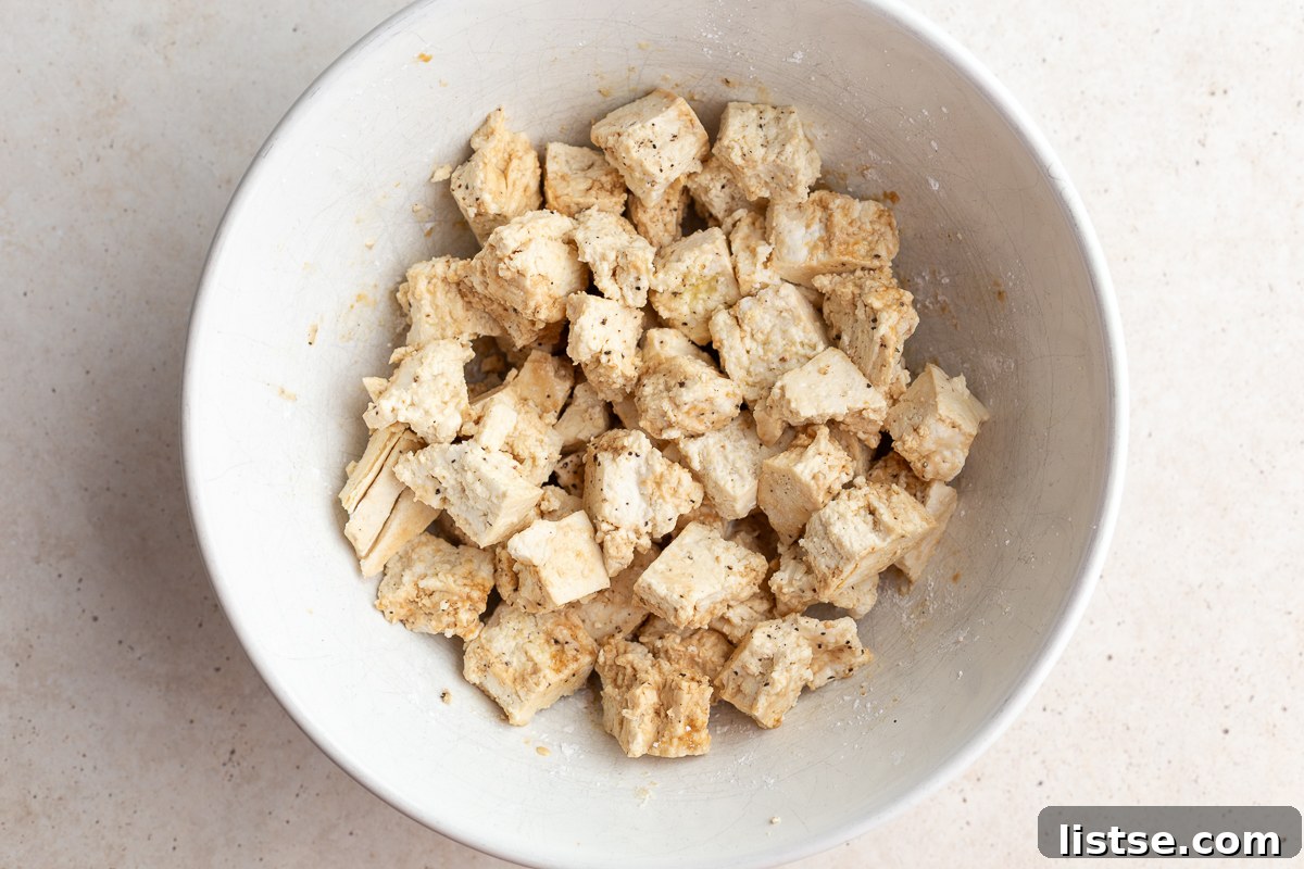Crispy Bang Bang Tofu: Air Fry or Pan Fry 5 tofu chunks in a large white bowl