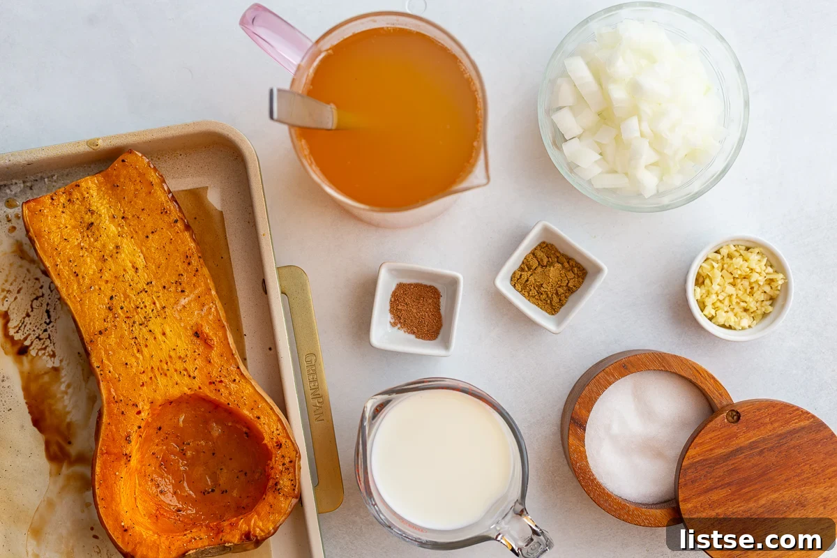 ingredients needed to make Creamy Roasted Butternut Squash Soup including squash, broth, milk, onion, spices, salt, and garlic