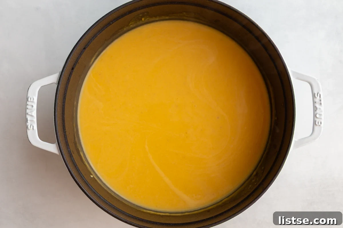Creamy Roasted Butternut Squash Soup in a large cast iron pot