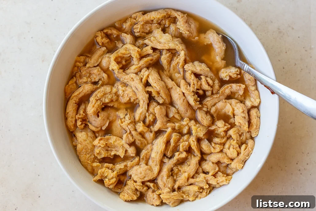 Quick and Cozy Vegan "Chicken" Noodle Soup 6 Dried soy curls being rehydrated in a bowl with warm water and bouillon.