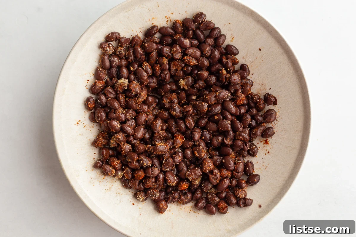 Effortless Meatless Quesadillas 6 Drained and rinsed black beans seasoned with spices in a white bowl.