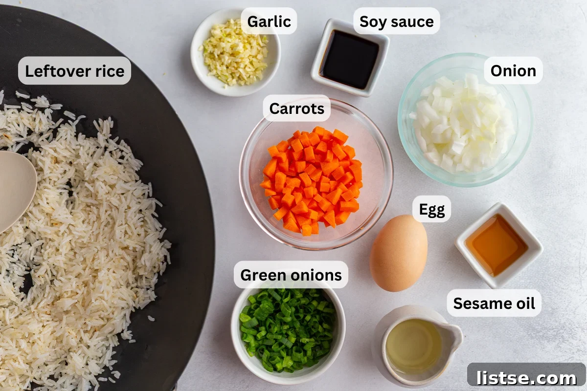 A beautifully arranged flat lay photograph showcasing all the fresh, colorful ingredients needed to make delicious homemade veggie fried rice, including cooked white rice, vibrant sliced carrots, fresh green onions, aromatic garlic cloves, bottles of neutral cooking oil and soy sauce, ready for preparation.