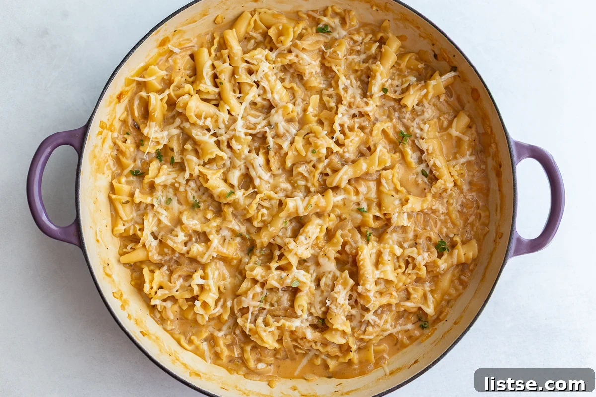 Finished creamy French onion soup pasta in a large skillet, ready to serve