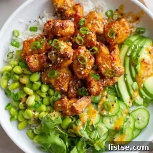 Crispy Tofu Bowls artfully arranged with edamame, fresh cucumber slices, and creamy avocado, ready to be enjoyed.