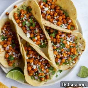 Delicious chickpea tacos served with a fresh lime wedge and cilantro.