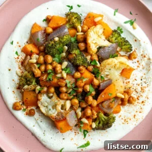 Pink plate with whipped feta and roasted veggies on it