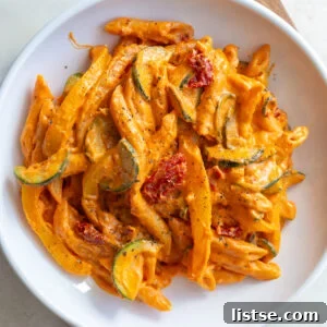 Weekly Culinary Guide 42 3 A white bowl filled with creamy one-pot tomato pasta and garnished with fresh basil.