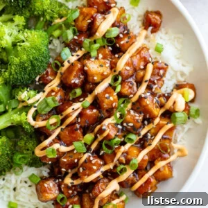 Weekly Culinary Guide 42 6 Crispy honey garlic tofu served in a bowl with white rice, steamed broccoli, and a sprinkle of sesame seeds and green onions.