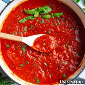 Weekly Culinary Guide 42 8 A skillet of vibrant, quick homemade marinara sauce with a wooden spoon and fresh basil.