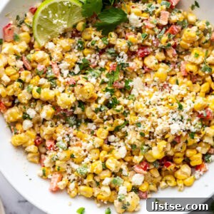 Weekly Culinary Guide 42 9 A large white bowl of Mexican Street Corn Salad (Esquites) topped with cotija cheese and fresh cilantro.