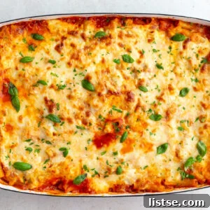 classic baked ziti without meat in a large casserole dish and topped with fresh basil