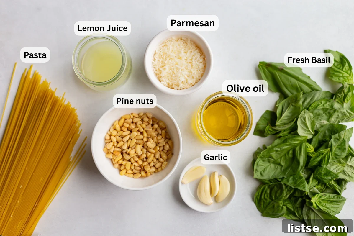 ingredients needed to make homemade pesto pasta including pasta, garlic, lemon, pine nuts, and basil