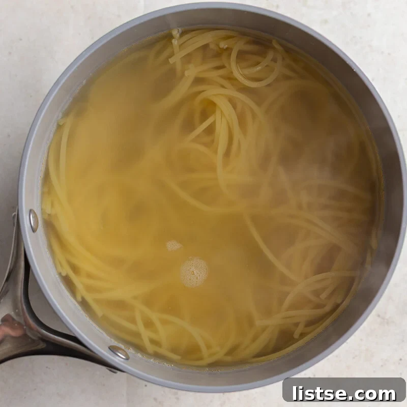 spaghetti cooked in a pot with water