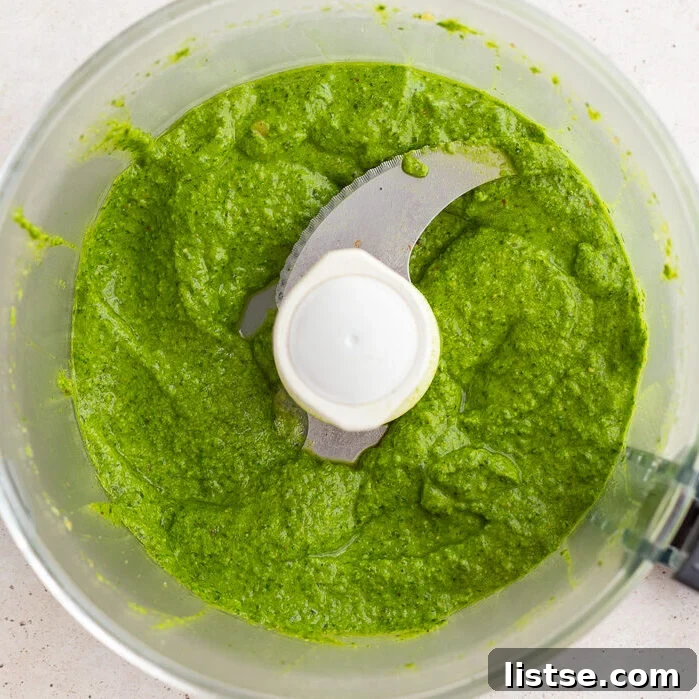 fresh homemade pesto blended up in a food processor base.