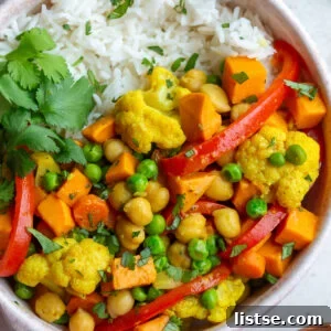 chickpea and sweet potato curry in a bowl served on white rice with cilantro