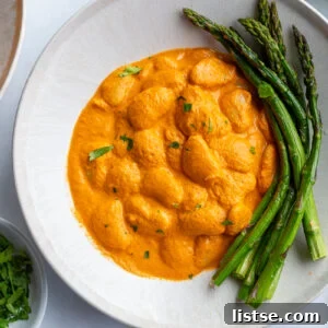 romesco butterbeans in a bowl with asparagus