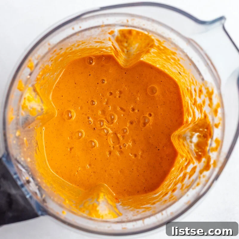 bright orange romesco sauce blended in a blender