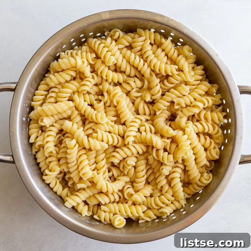 Pesto Pasta Salad with Cherry Tomatoes and Mozzarella 6 cooked rotini pasta in a colander