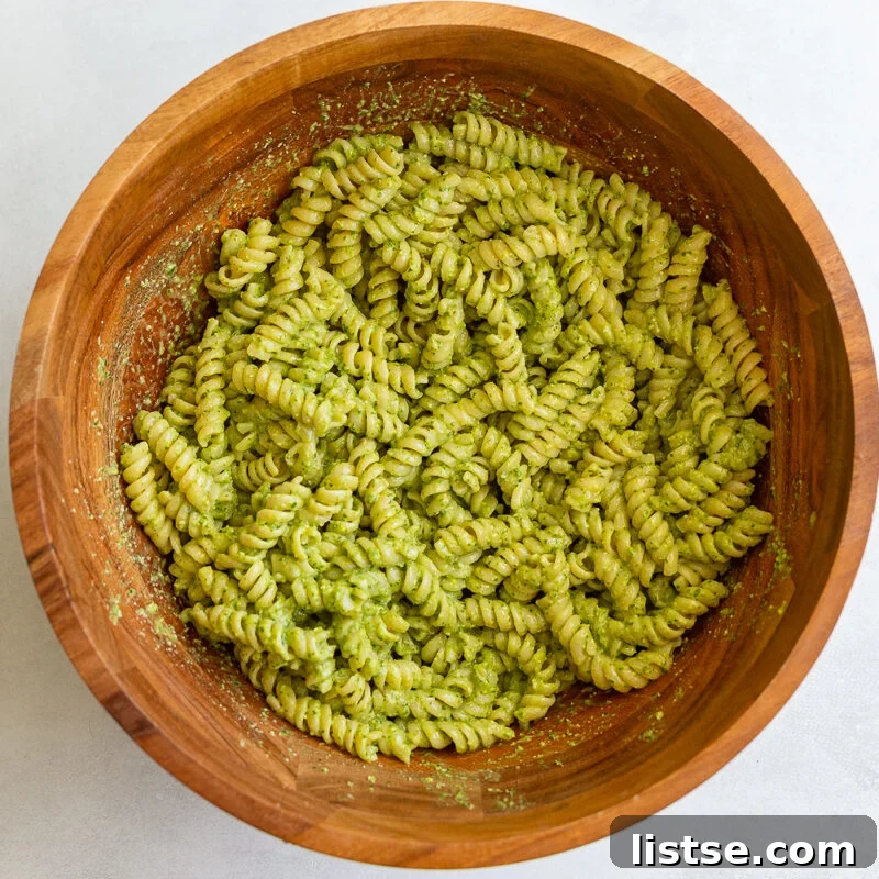 Pesto Pasta Salad with Cherry Tomatoes and Mozzarella 7 pesto pasta in a large wood bowl