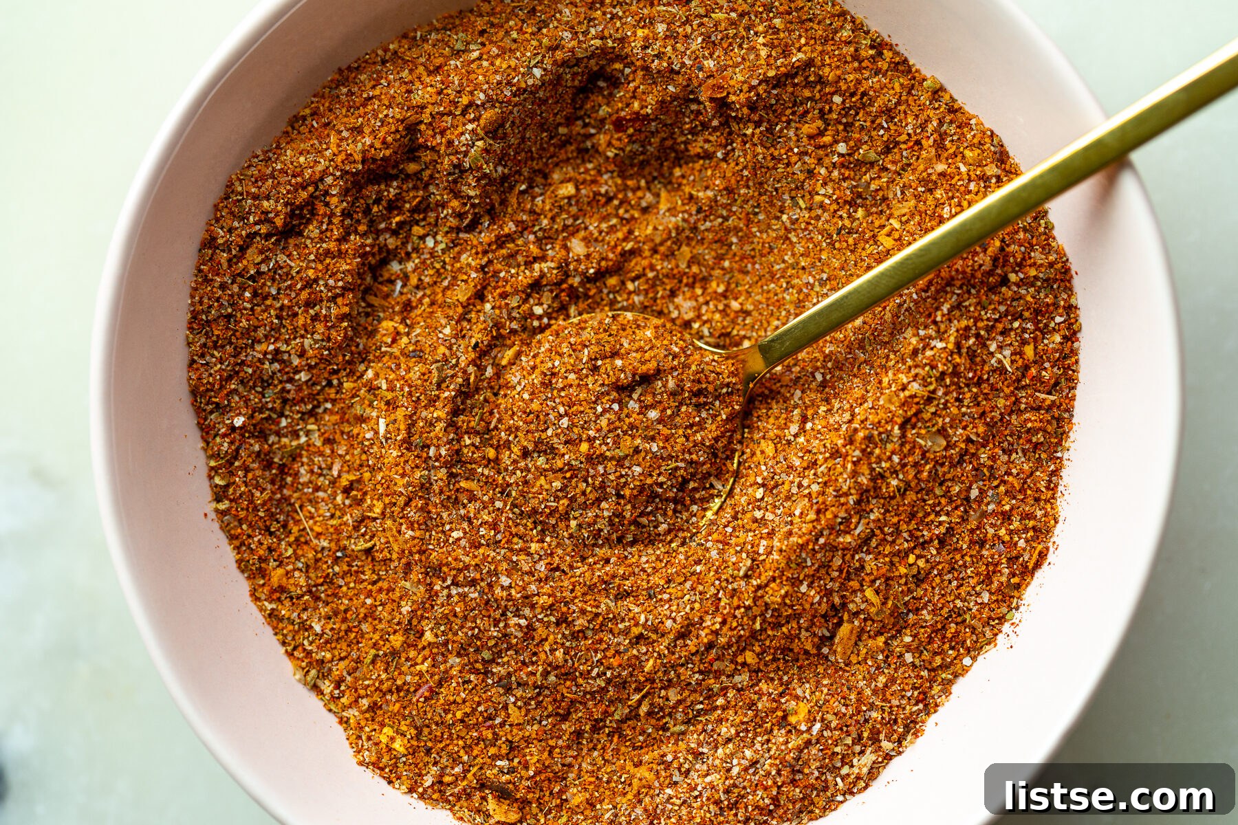 Homemade Fajita Seasoning Mix for Chicken and Steak 2 homemade fajita seasoning in a small bowl with a gold spoon dipped in it