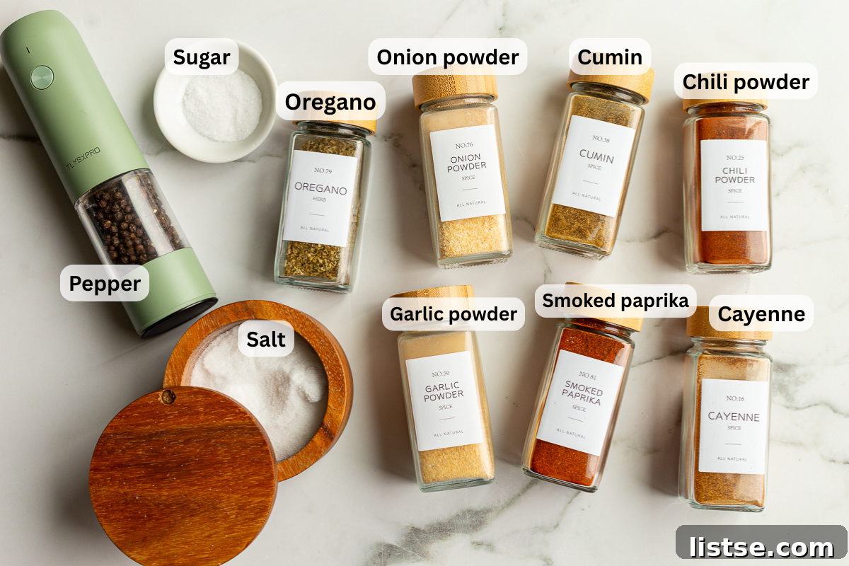 Homemade Fajita Seasoning Mix for Chicken and Steak 4 ingredients for fajita seasoning laid out with names of spices including smoked paprika, chili powder, onion powder, garlic powder, salt and pepper