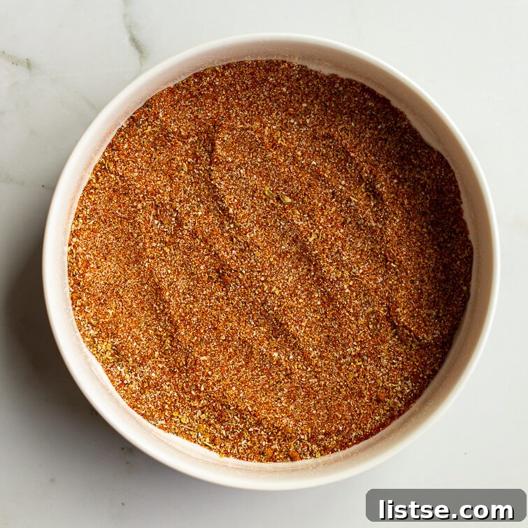 Homemade Fajita Seasoning Mix for Chicken and Steak 7 homemade fajita seasoning fully blended together in a white bowl on a white marble surface