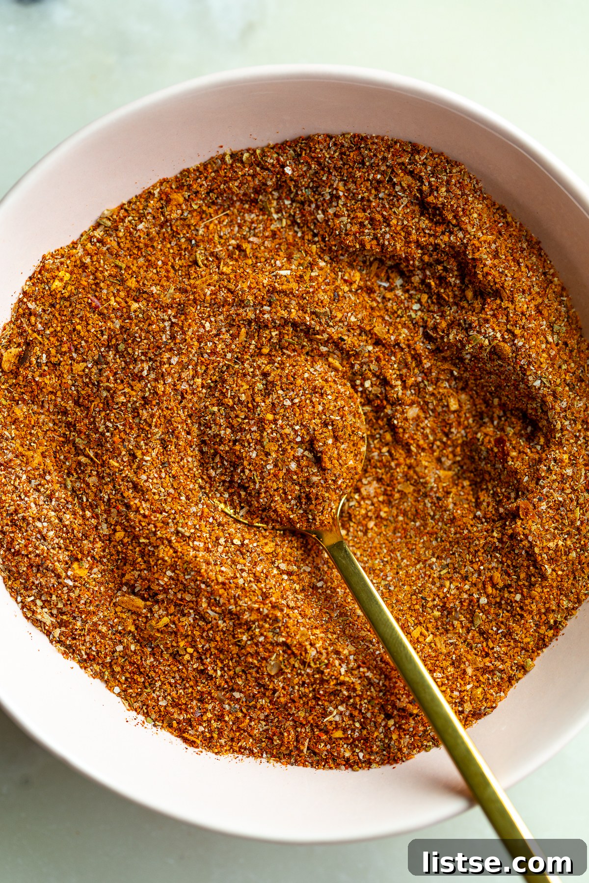 Homemade Fajita Seasoning Mix for Chicken and Steak 8 homemade fajita seasoning in a small bowl with a gold spoon dipped in it