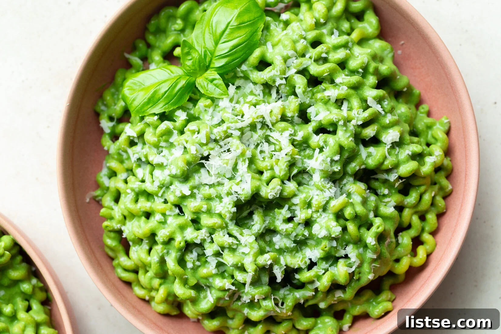 5 Tofu Pasta Sauce Recipes You'll Make Again 2 Green pasta garnished with basil leaves.