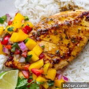 Cilantro-Lime Tofu with Fresh Mango Salsa 11 cilantro lime tofu that looks like grilled chicken with a mango salsa on top. all on a bed of rice