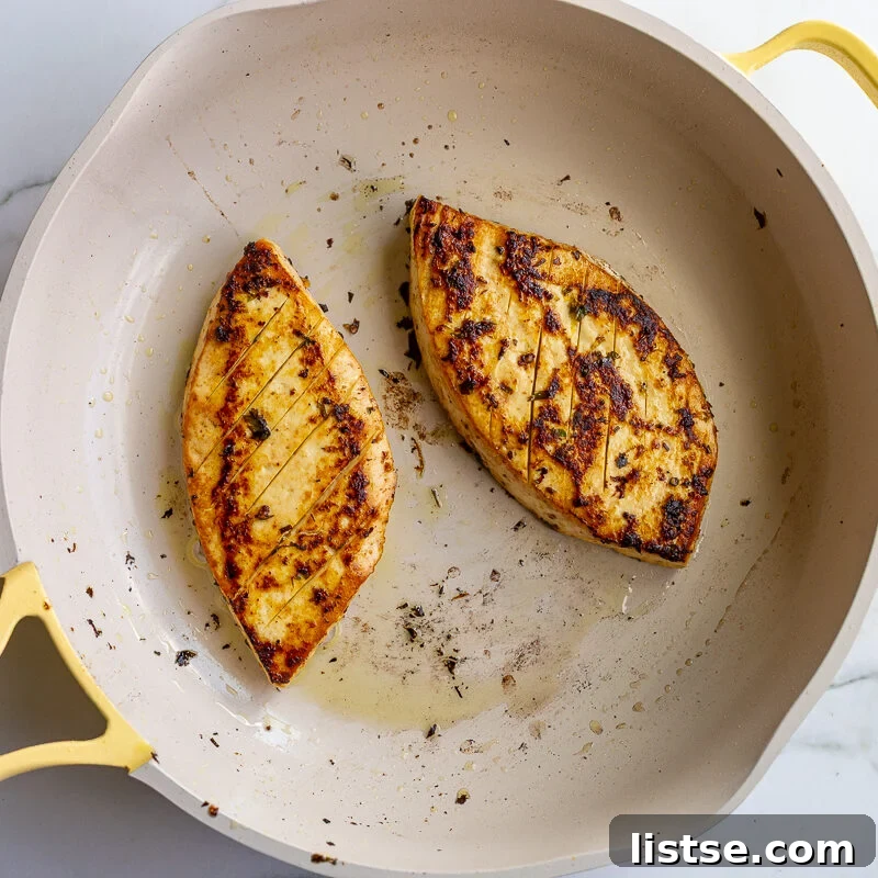 Cilantro-Lime Tofu with Fresh Mango Salsa 8 Two triangular slices of tofu seared golden brown with charred edges in a cream-colored skillet.