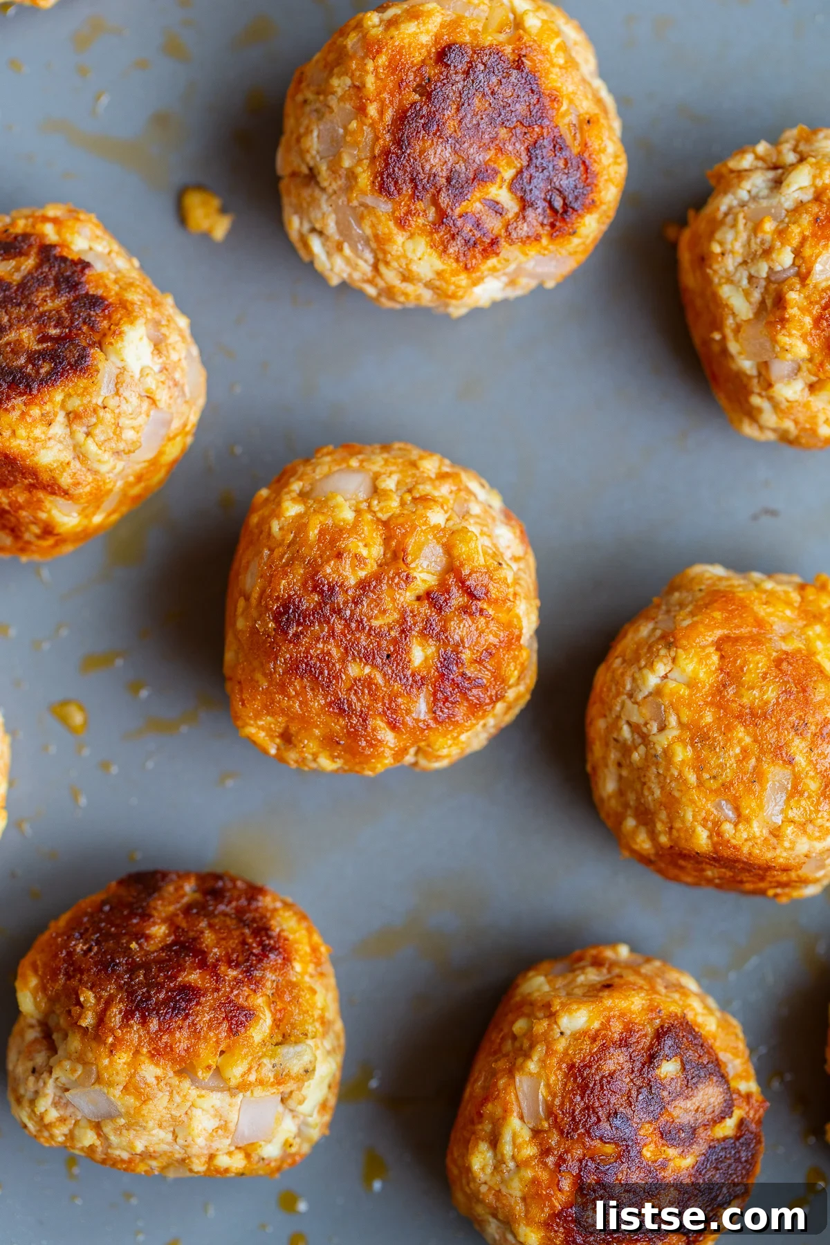 Crispy Vegan Tofu Meatballs: High-Protein Recipe 12 tofu meatballs on a baking tray