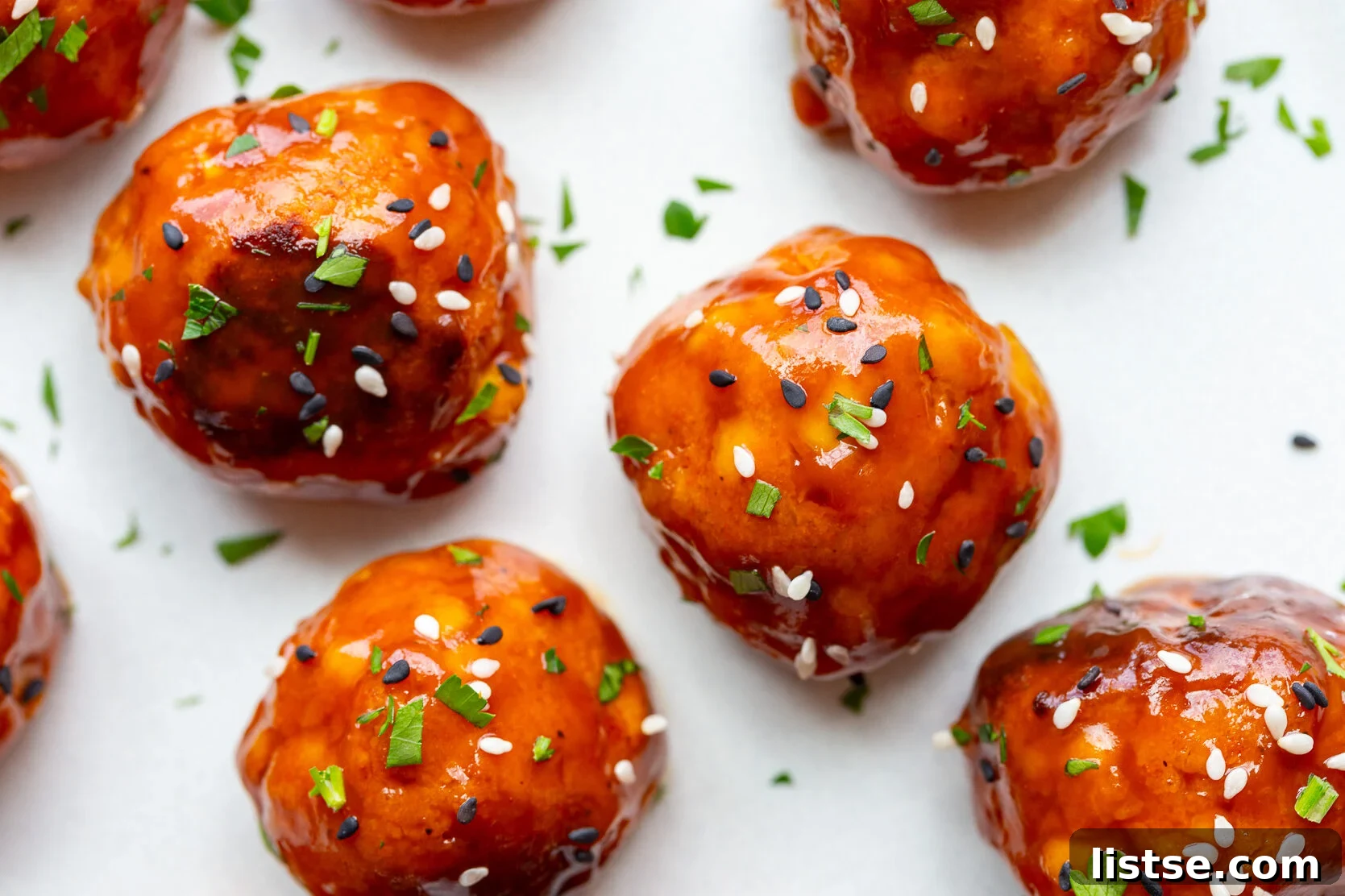 Crispy Vegan Tofu Meatballs: High-Protein Recipe 13 tofu meatballs covered in a sticky sauce and sesame seeds