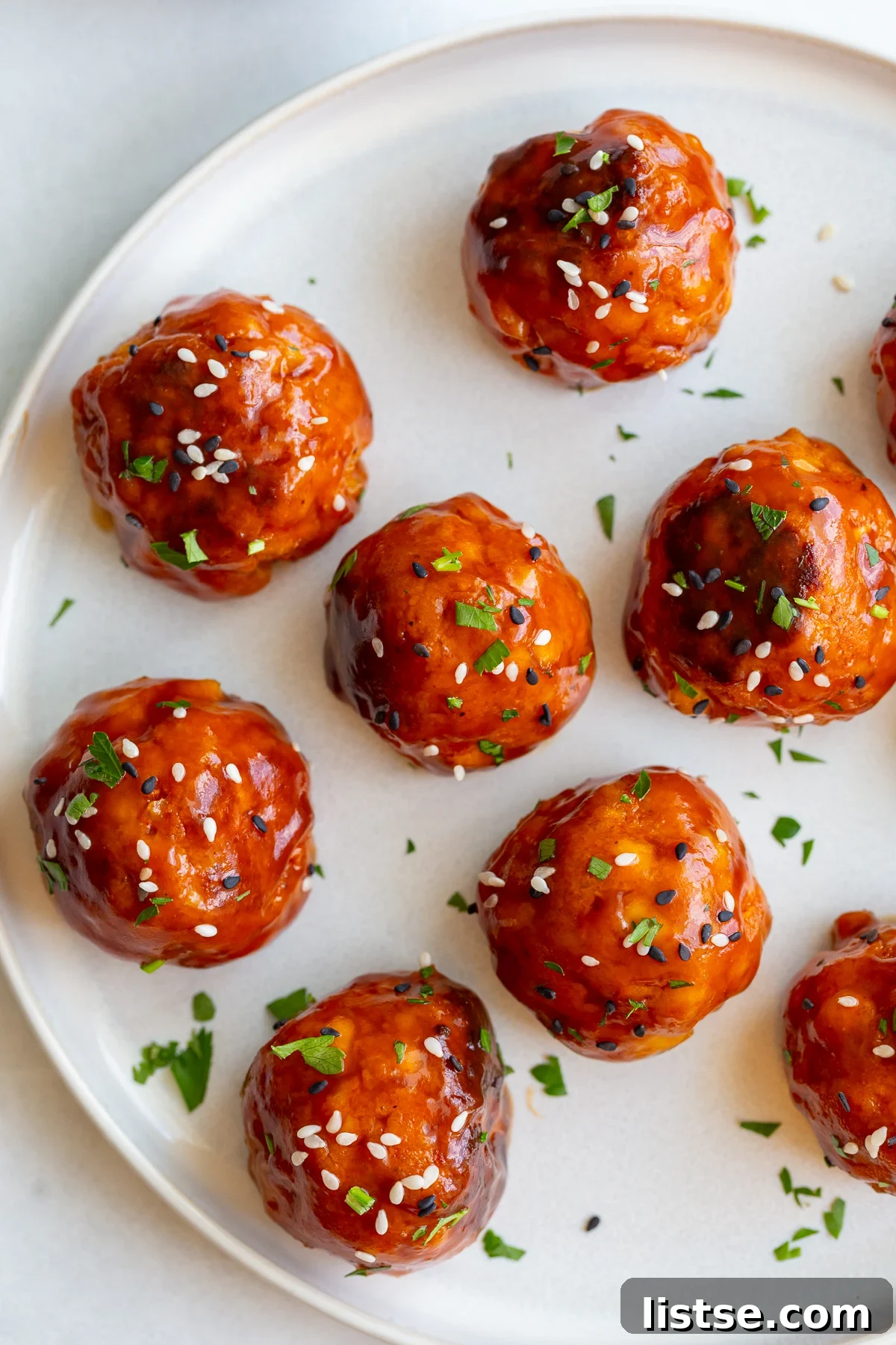 Crispy Vegan Tofu Meatballs: High-Protein Recipe 5 tofu meatballs covered in a sticky sauce and sesame seeds
