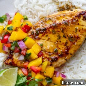 cilantro lime tofu that looks like grilled chicken with a mango salsa on top. all on a bed of rice